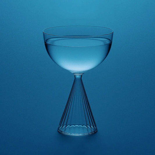Electrolyte water in an elegant glass representing premium hydration; highlights the role of sodium, potassium, and magnesium malate in energy production, muscle function, heart health, and stress relief through advanced electrolyte balance.